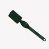 En grön snittkniv i plast med ett ergonomiskt handtag och en skyddande hylsa över bladet. Kniven ligger på en vit bakgrund.